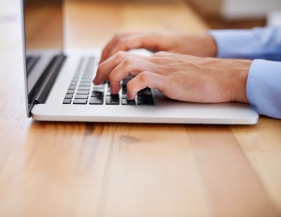 Cropped image of a business working on his laptop