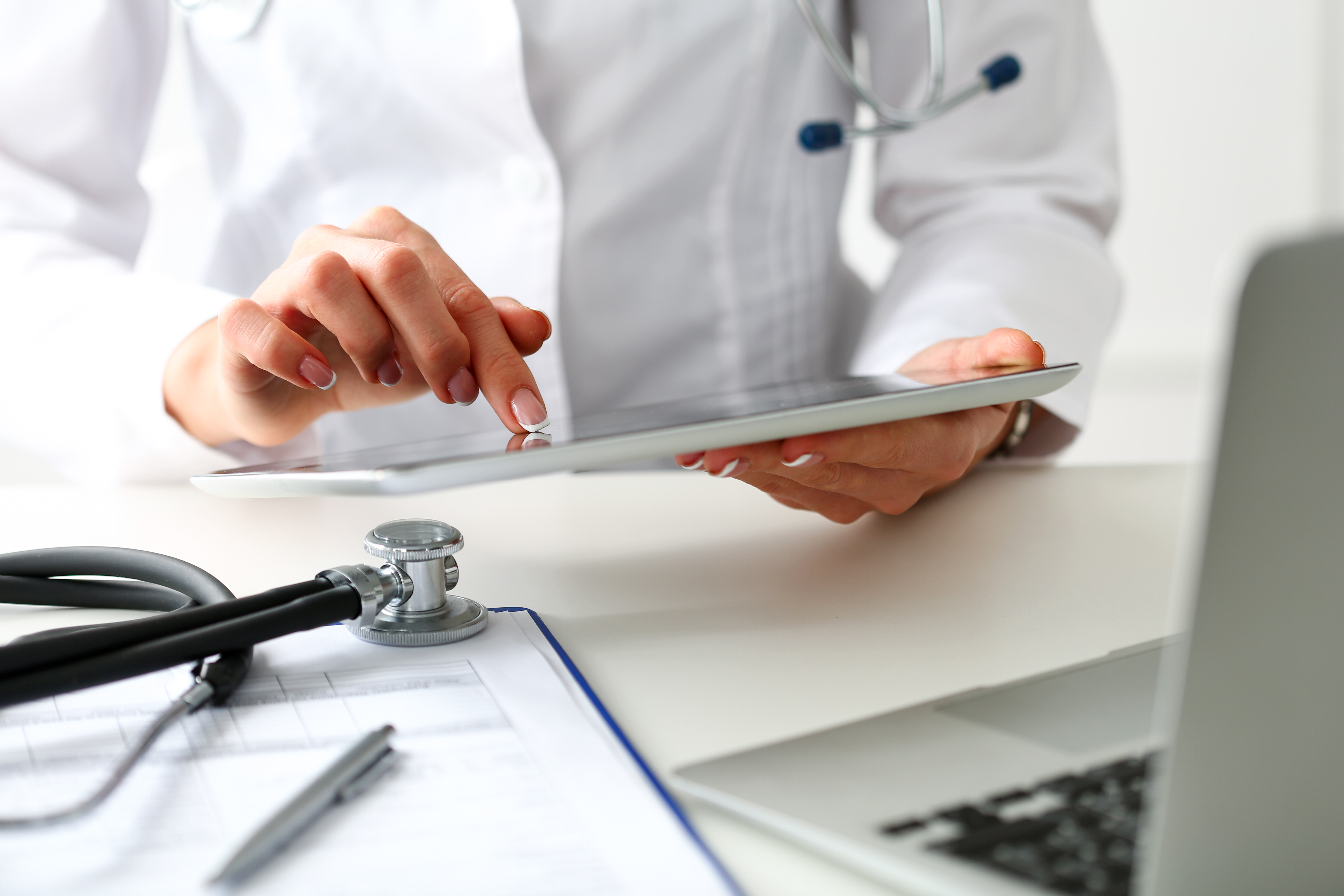 Female doctor hold digital tablet pc and point in touch screen with finger closeup. Human interaction, professional consultation, therapeutist examine test results, new search opportunities concept