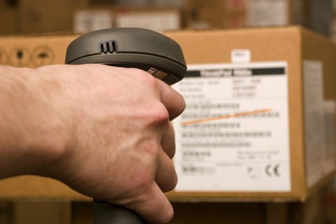 A man gets on the hip skaner in operations directed on printed barcode