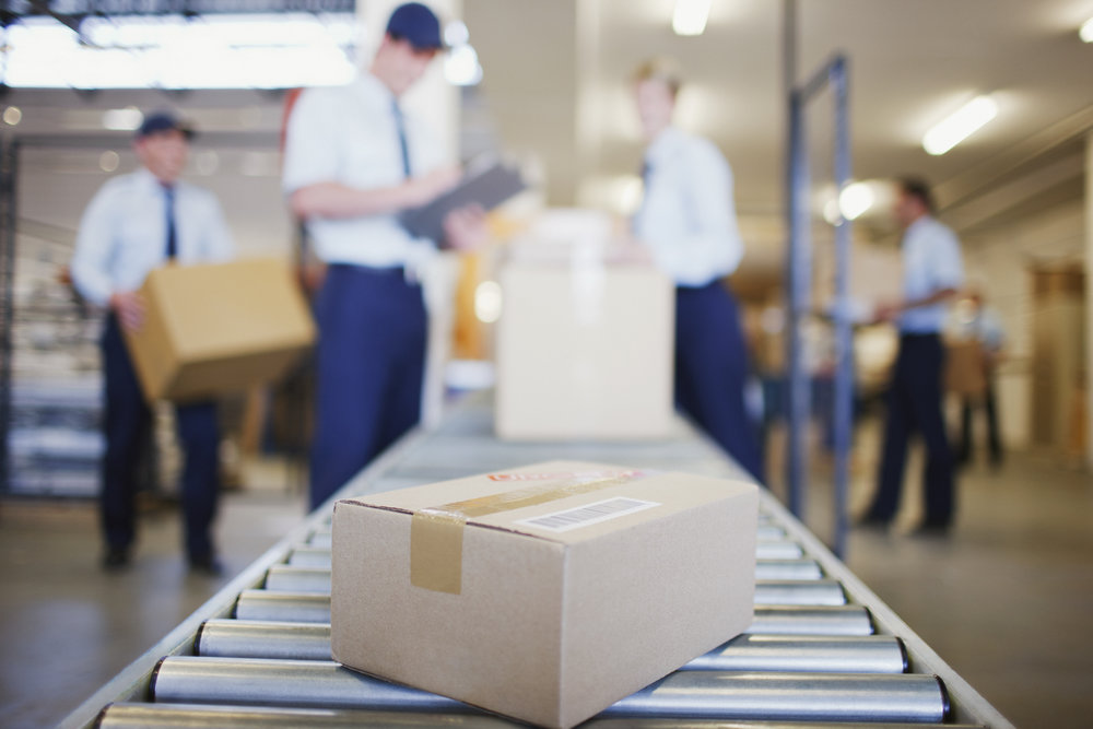 Box on conveyor belt in shipping area