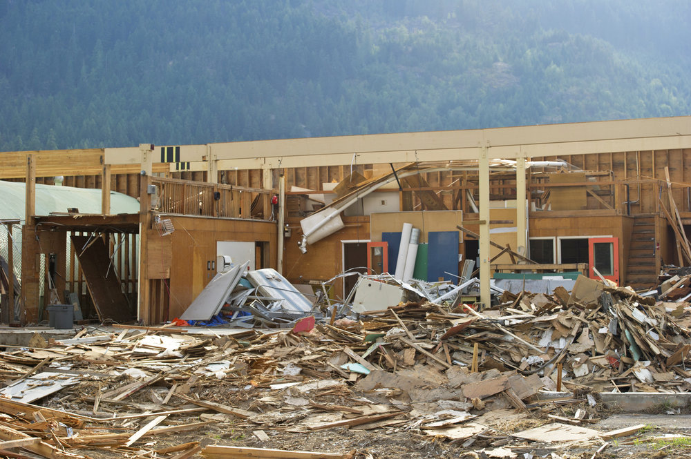 Pile of structural debris at a severly damaged building