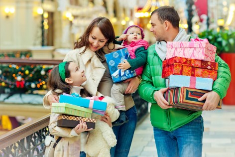 Family buying Christmas gifts in a shopping mall