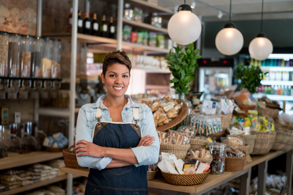 Latin American woman working at a grocery store - small business concepts