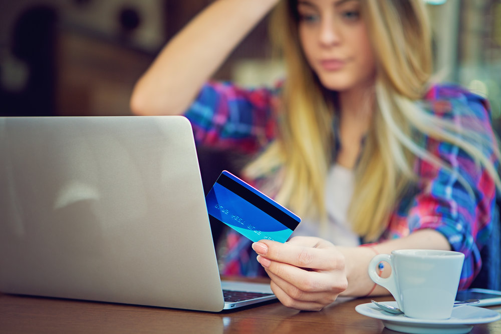 Young girl is shopping online using her credit card.