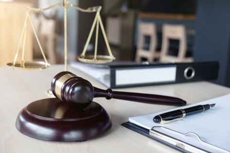 Close up of gavel and scales of justice and Report the case with paper on wooden table in office, Law and justice concept.