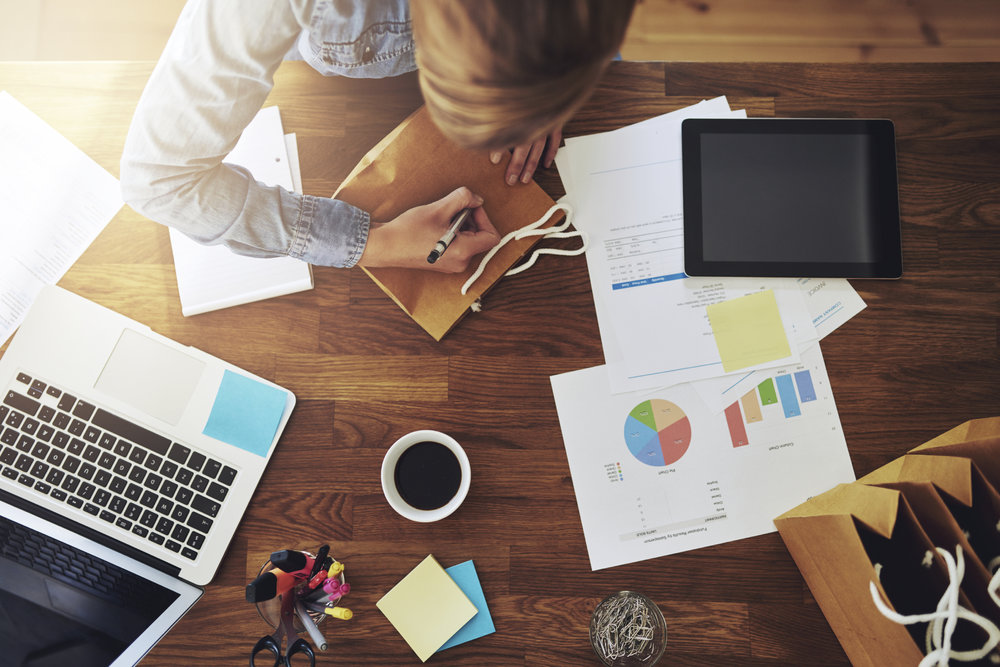 Young female entrepreneur working in a home office at her desk