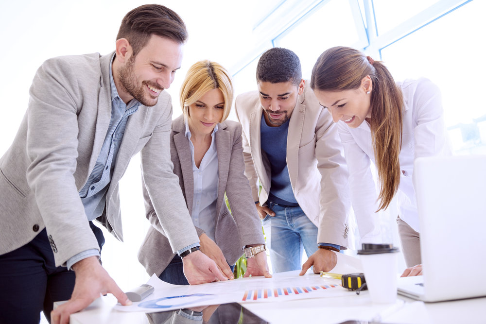 Image of four successful business partners working at meeting in office.Group of business people discussing.They are working on a new project.